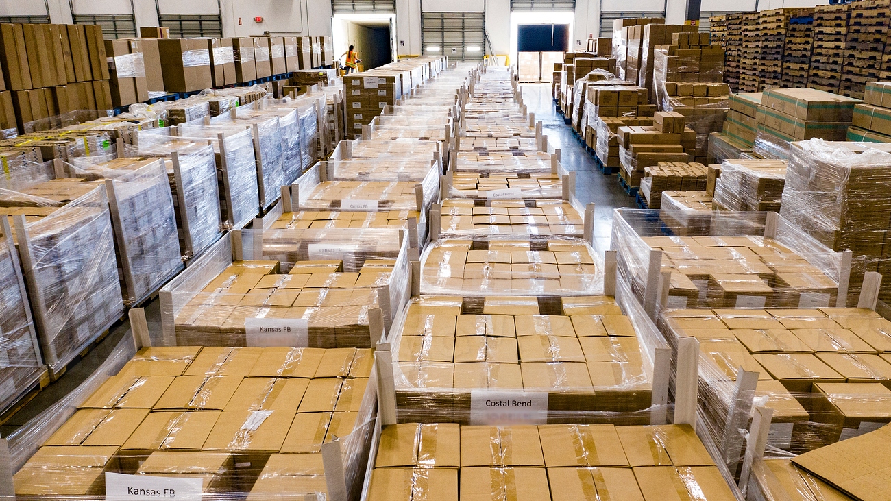 Palletized cartons of paper packaging stock in a warehouse
